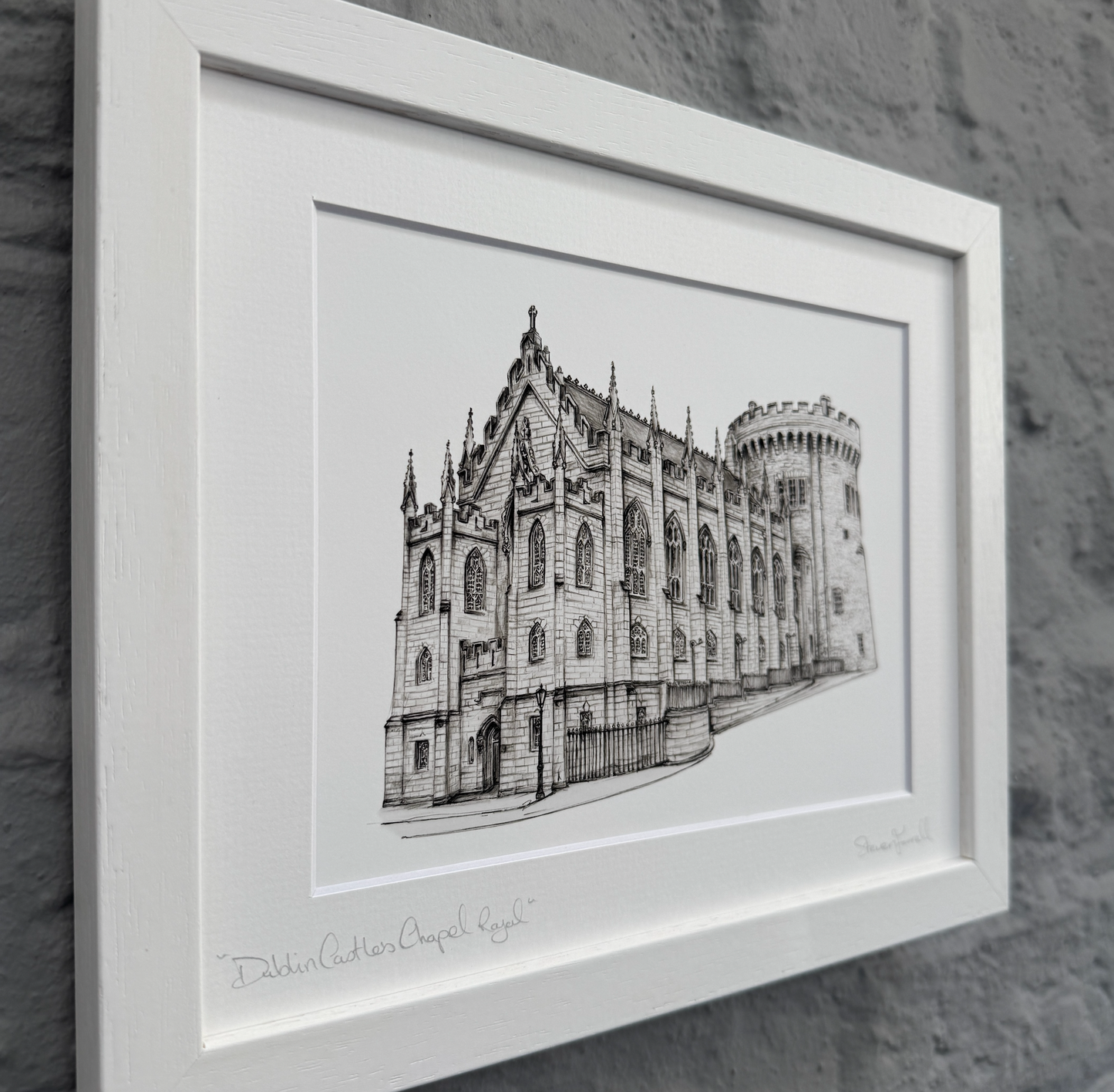 Framed black and white illustration of a cathedral on a stone wall background